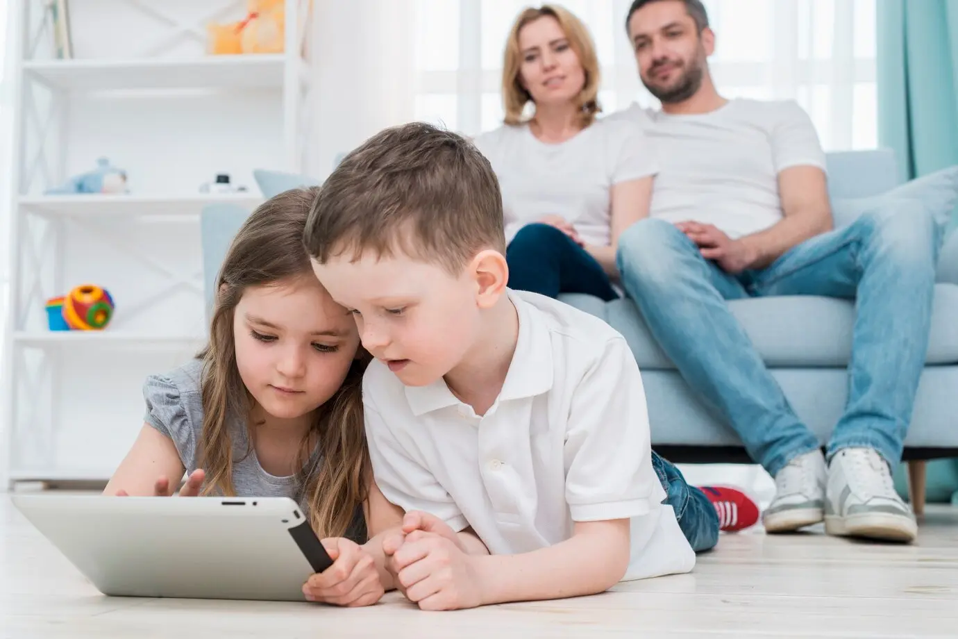 Parents watching children playing with iPad